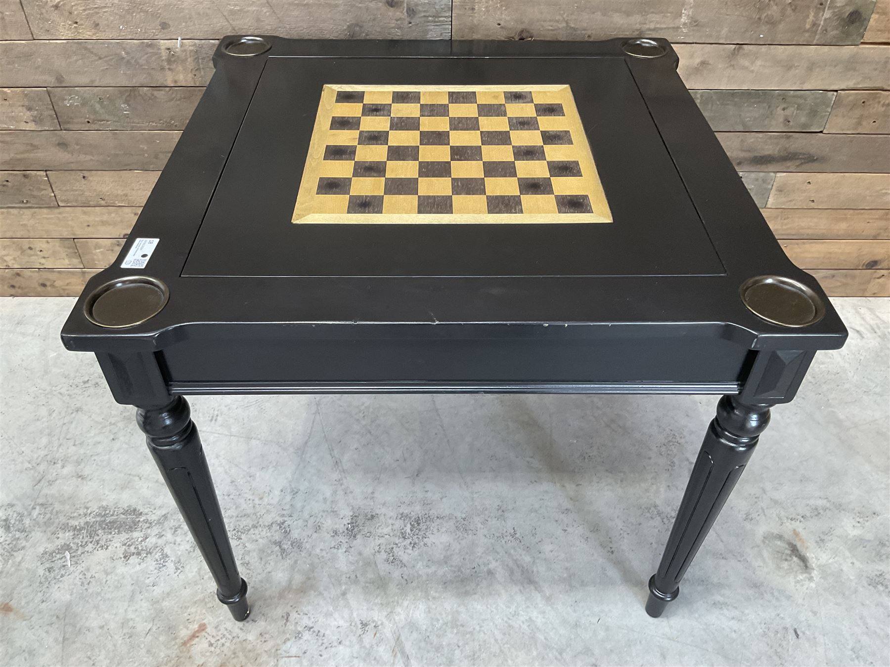 Ebonised square games table, reversible chessboard top revealing games compartment