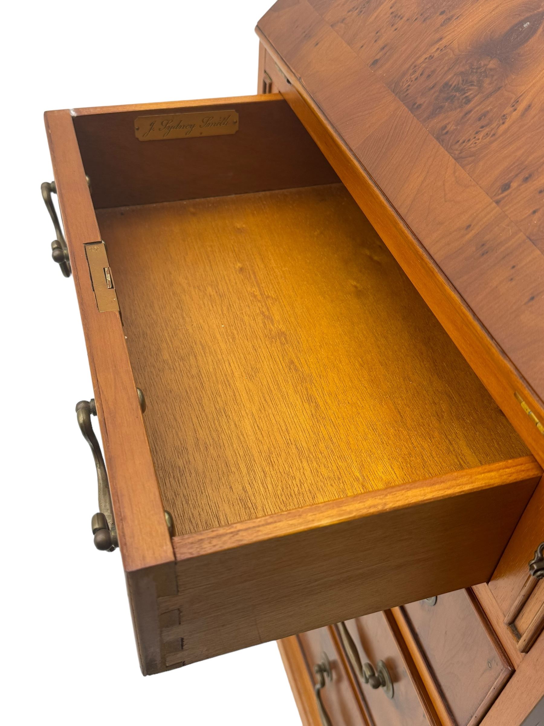 Mid-to-late 20th century yew wood bureau bookcase, raised bookcase enclosed by glazed door, the fall front revealing fitted interior, four graduating cock-beaded drawers below, on bracket feet