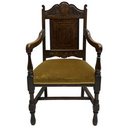 Late 19th to early 20th century oak elbow chair, the shaped cresting rail carved with scrolls and foliage, panelled back inlaid with parquetry work and central rampant lion within shield, upholstered seat, on turned supports joined by H stretchers