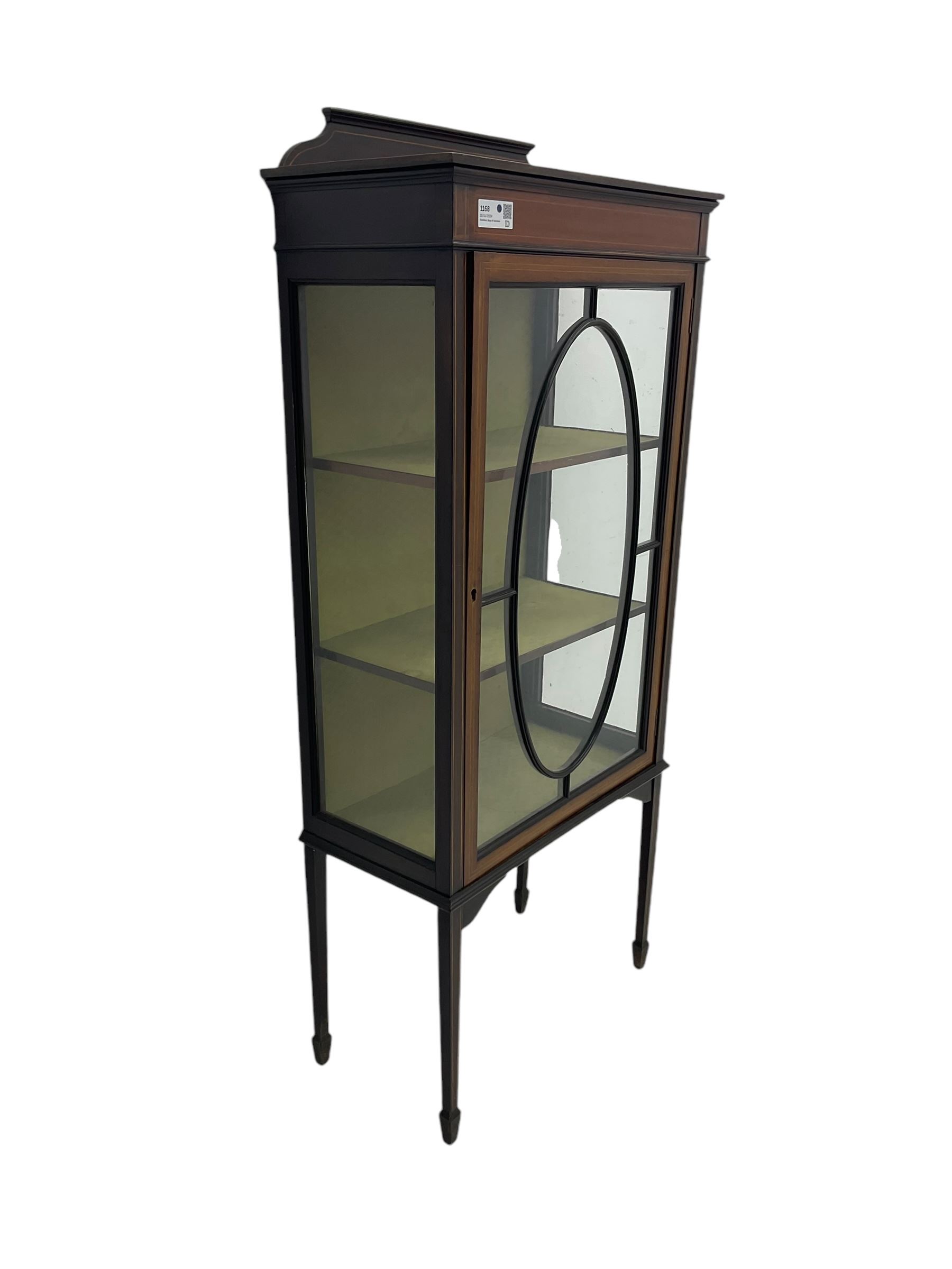 Edwardian inlaid mahogany display cabinet, shaped and raised back over single astragal glazed door, interior lined and fitted with two shelves, raised on square tapering supports