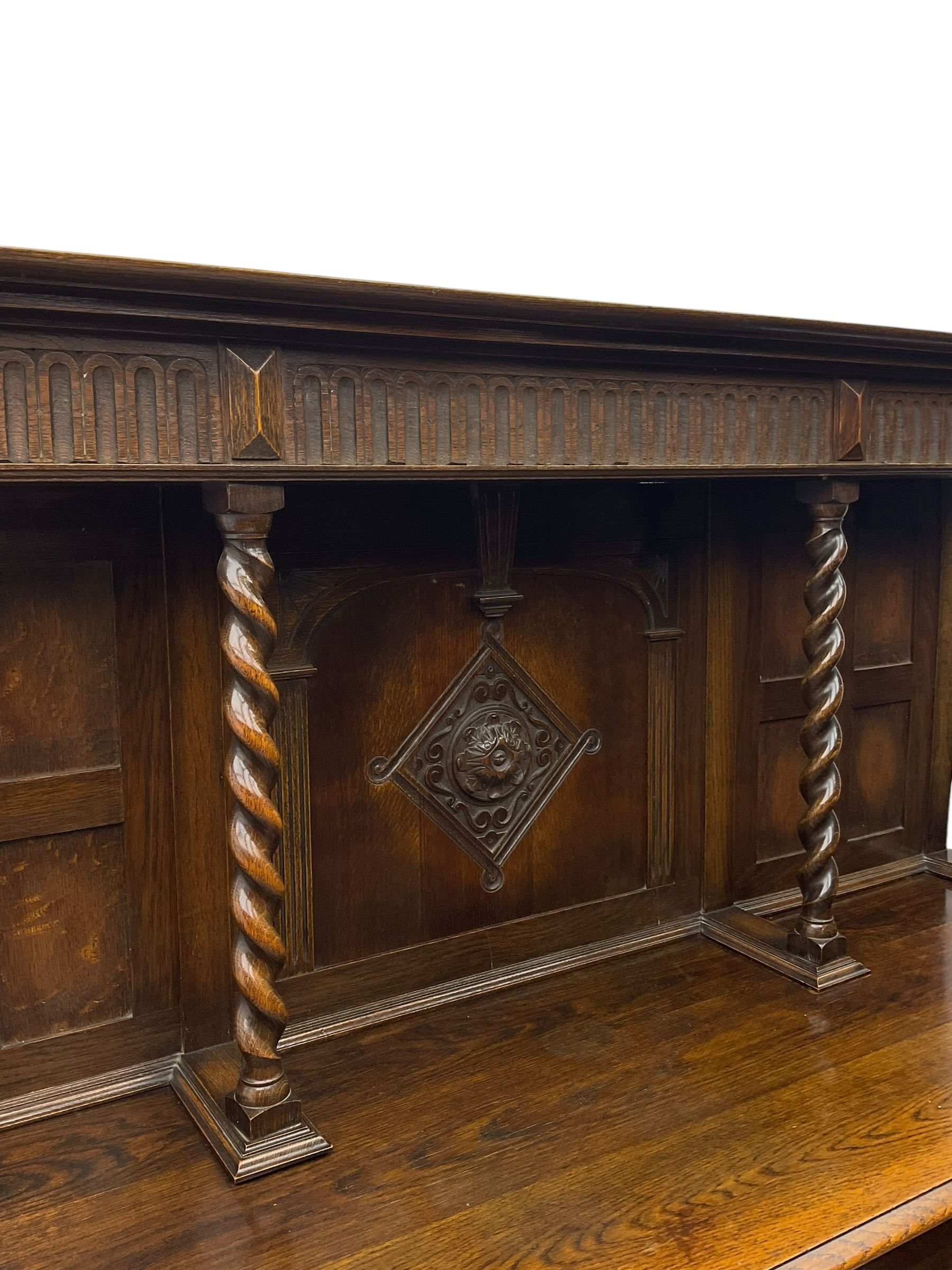 Jacobean Revival oak dresser, projecting moulded cornice over arcade carved frieze and panelled back, on spiral turned supports, moulded rectangular top over two cupboards and two drawers, on spiral turned supports united by moulded stretchers 