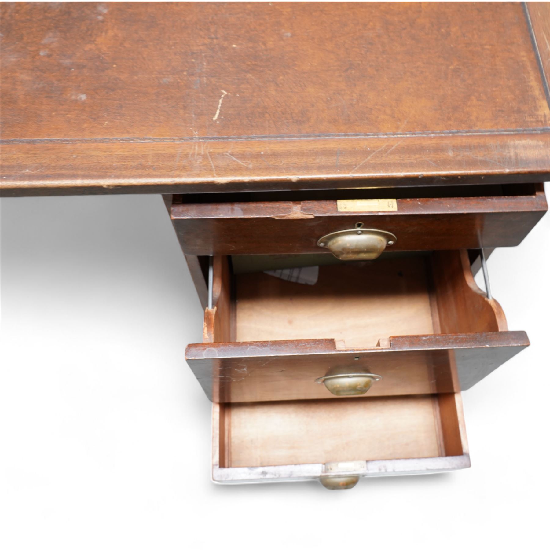 Early 20th century mahogany twin pedestal desk, rectangular top with brown leather inset, fitted with six drawers with brass cup handles, moulded plinth base