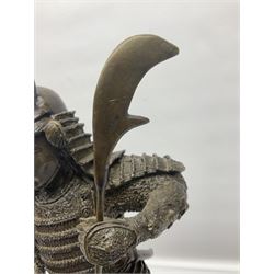 Bronze figure of a samurai standing wearing armour and holding a naginata, upon a rocky base, H48cm