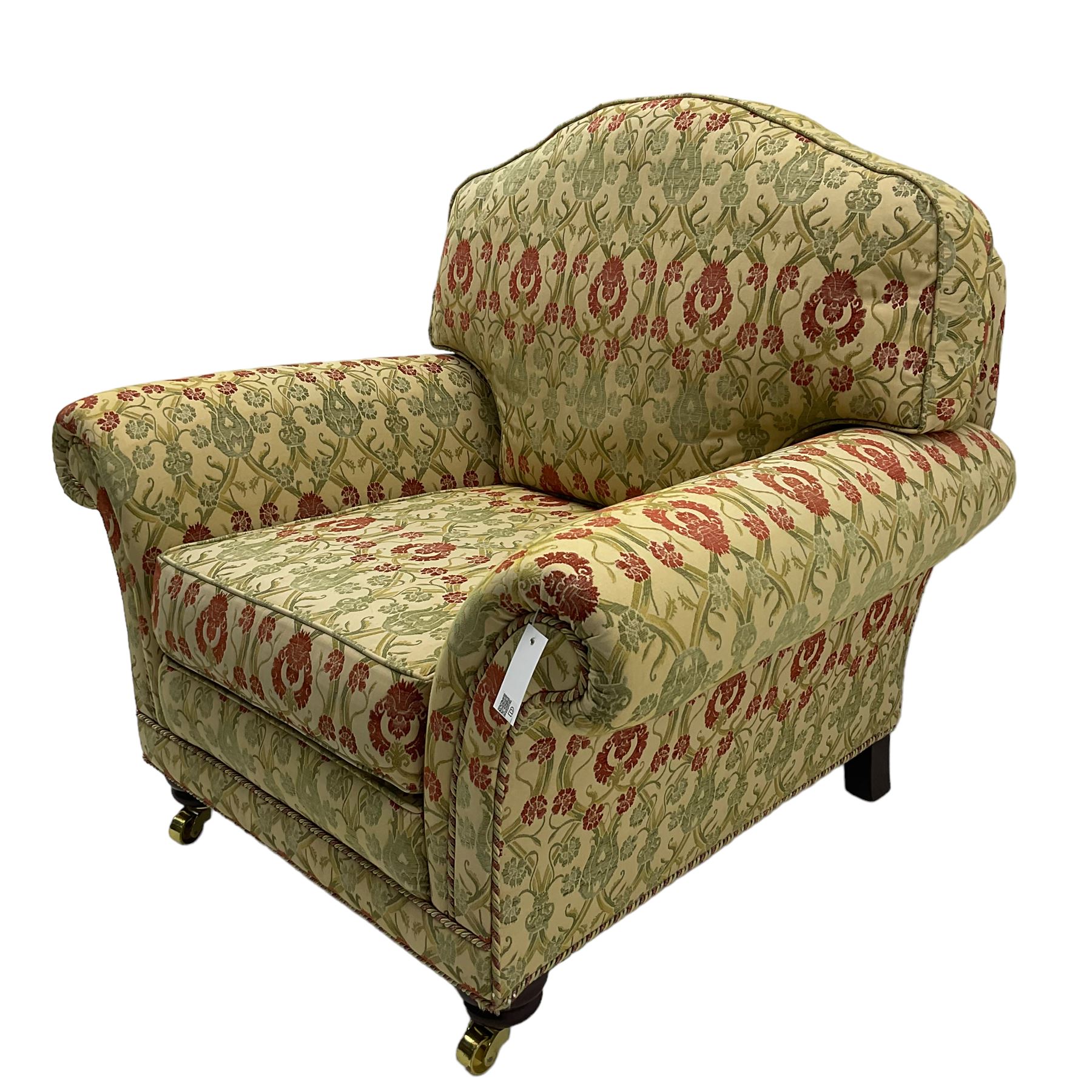 Traditional design two seat sofa, high back with scrolled arms, upholstered in beige fabric with red and green damask motifs, on castor supports (L178cm, D100cm, H89cm); matching armchair (L109cm, D89cm, H89cm)