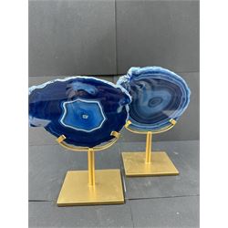 Pair of blue agate slices, polished with rough edges, raised upon gilt metal stands, H20cm