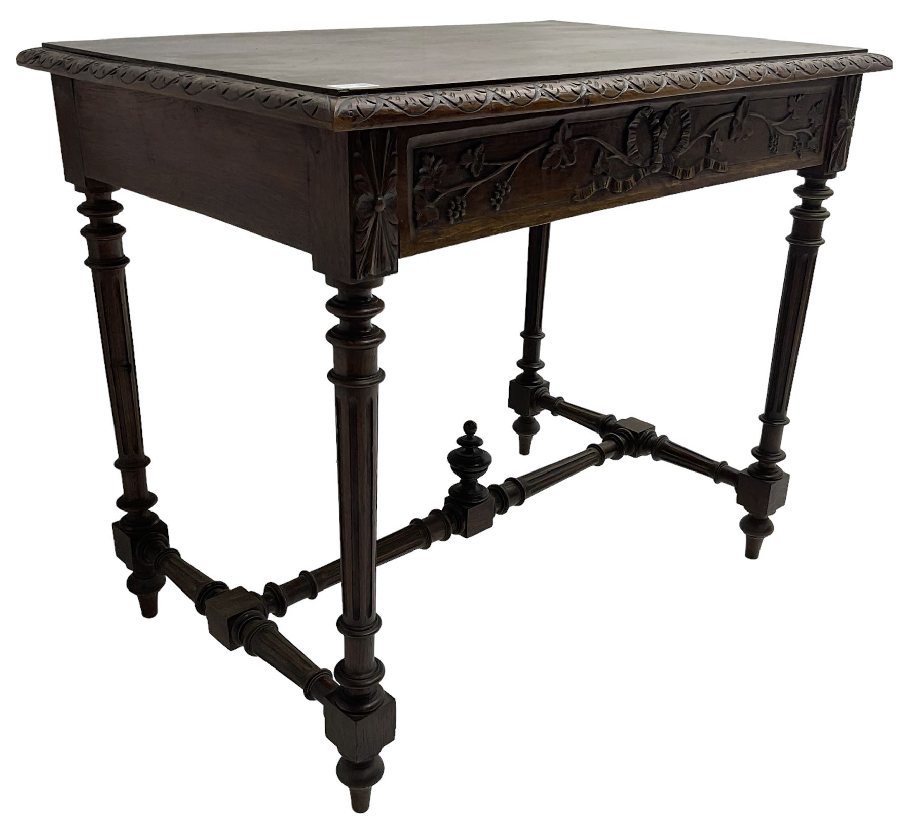 19th century walnut side table,  rectangular top with lunette carved moulded edge, the frieze drawer carved with ribbon and extending vine branch and grapes, on turned and fluted supports united by fluted stretcher with centre finial 