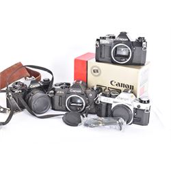 Four Canon SLR camera bodies, to include AE-1 Program, in black and silver finish, serial no. 4330401, boxed, AE-1 serial no. 1234206 and two AV-1 examples, serial nos. 841957 & 334882, one with a Canon FD 50mm 1:18 lens