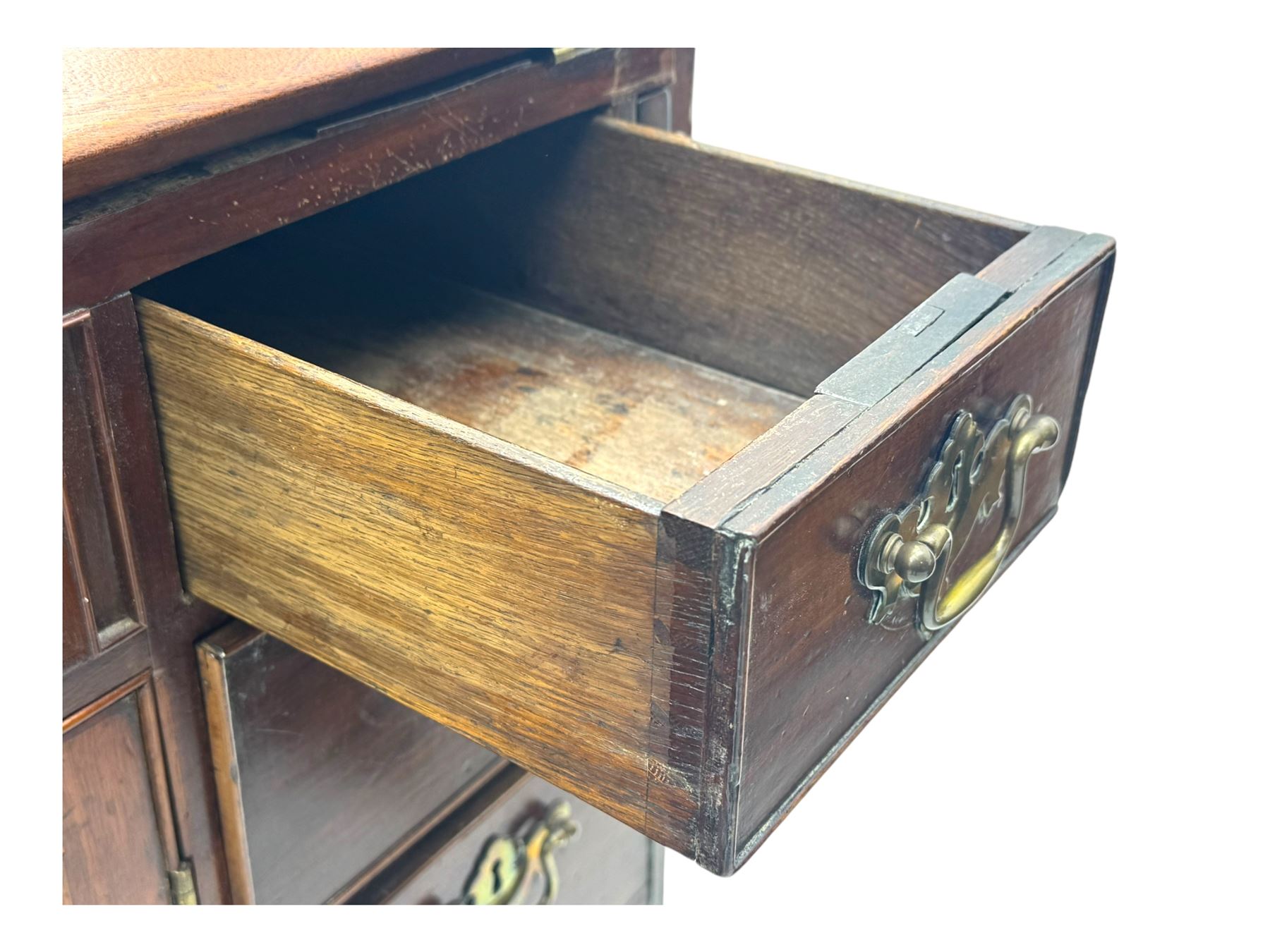 George III mahogany bureau, the fall-front enclosing fitted interior with pigeonholes and central cupboard, over an arrangement of nine short drawers surrounding a central cupboard, on shaped bracket feet