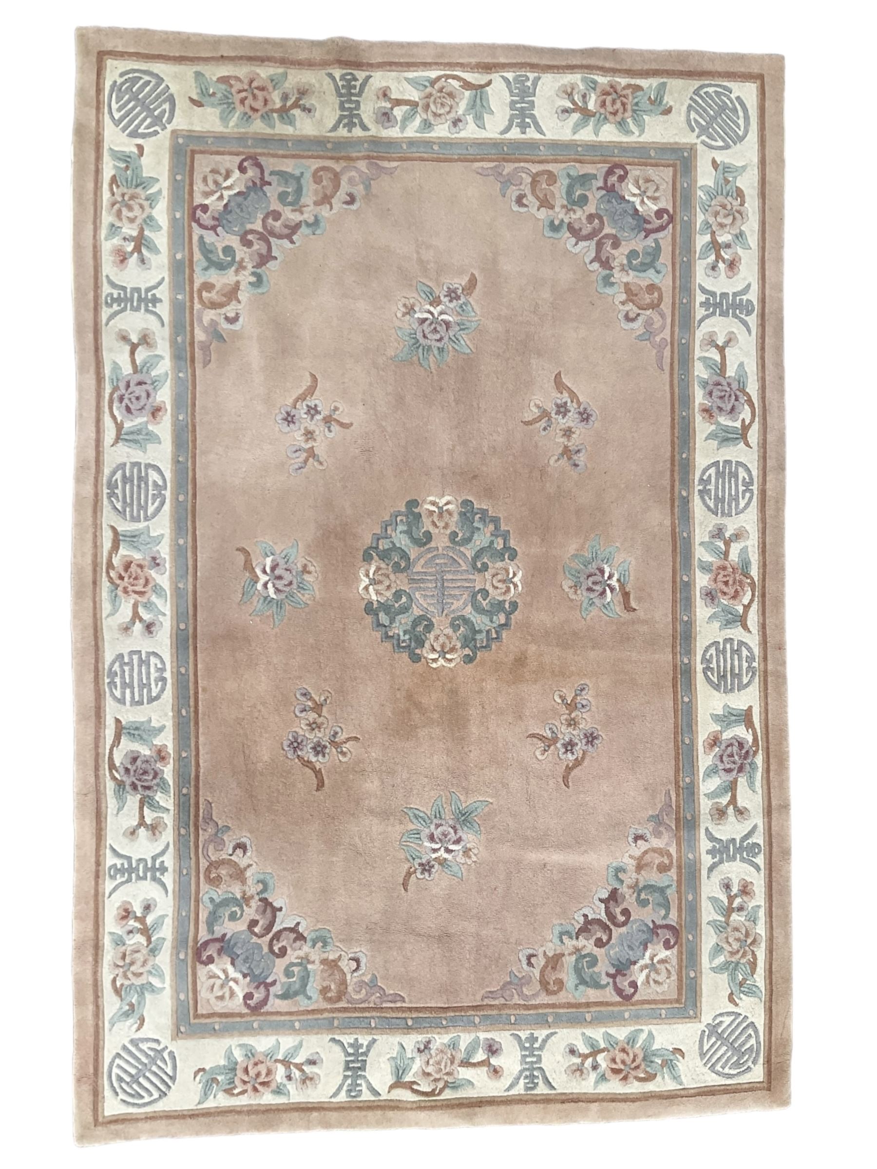 Chinese washed woollen pink ground rug, decorated with floral bouquets and Chinese symbols 