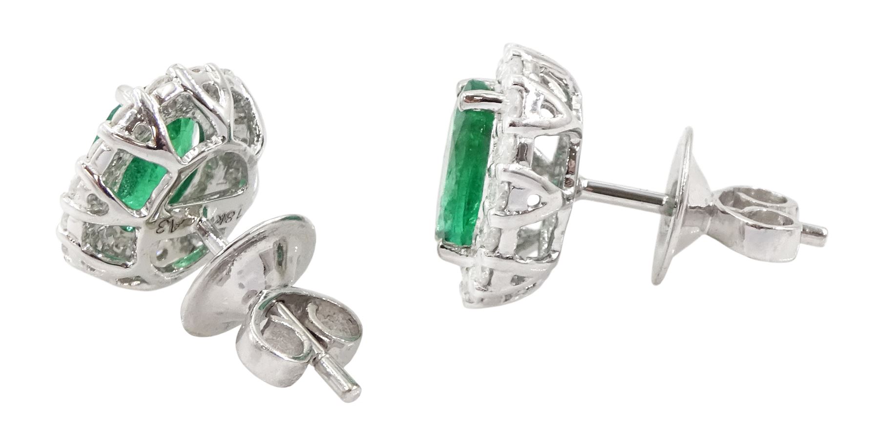 Pair of 18ct white gold oval cut emerald and round brilliant cut diamond stud earrings, stamped, total emerald weight approx 1.95 carat, total diamond weight approx 0.60 carat