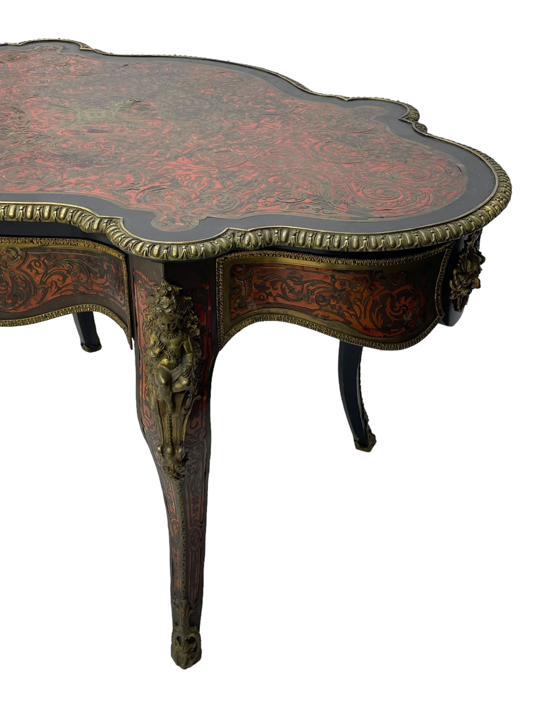 Victorian Louis XV design boulle work centre table, shaped form, decorated extensively with brass and red tortoise shell scroll work, central extending acanthus leaves surrounded by scrolling foliage, gardroon and floral cast brass edge, the frieze rails decorated with further boulle work and green man gilt metal cast masks, the cabriole supports mounted by seated putti mounts on S-scroll brackets surrounded by oak leaves and acorns, ornate scroll and floral cast terminal caps