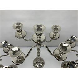 Pair of four branch candelabra, urn-shaped nozzles raised upon scroll branches supported from tapering central stem, with a stepped circular base, with another similar, pair H40cm