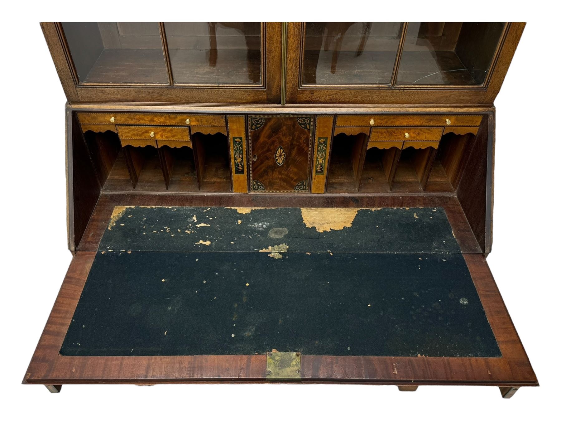 Early 19th century mahogany bureau bookcase, the projecting cornice over two Gothic-style astragal glazed doors enclosing two adjustable shelves, sloped hinged lid enclosing fitted interior and felt inset, four graduating drawers, on bracket feet