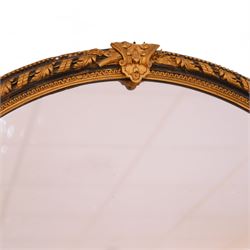 Large 19th century ebonised and parcel-gilt overmantle mirror, the oval plate within a gilt slip, framed by acanthus ribbon-twist decoration with outer beading, the shaped base decorated with scrolling foliate patterns and rosettes