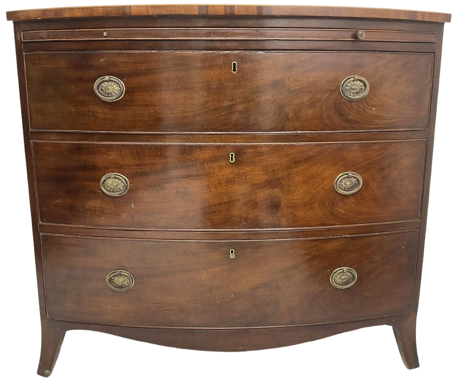 George III mahogany bow-front chest, shaped top with satinwood stringing, fitted with brushing slide over three graduating cock-beaded drawers, shaped apron over bracket feet