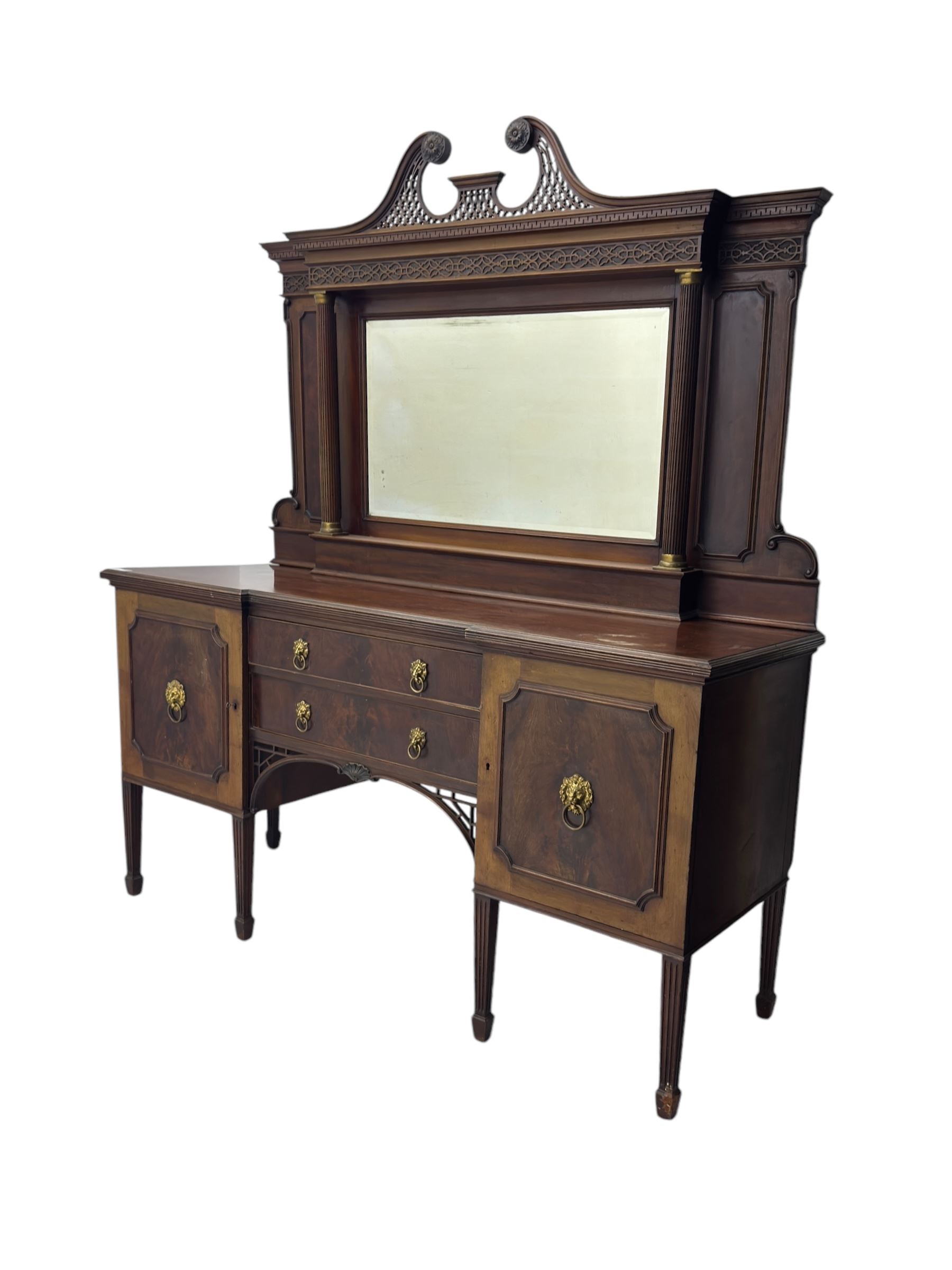 19th century mahogany sideboard, raised mirror back with carved fretwork and two fluted columns, above two cupboards and two drawers with lion mask handles