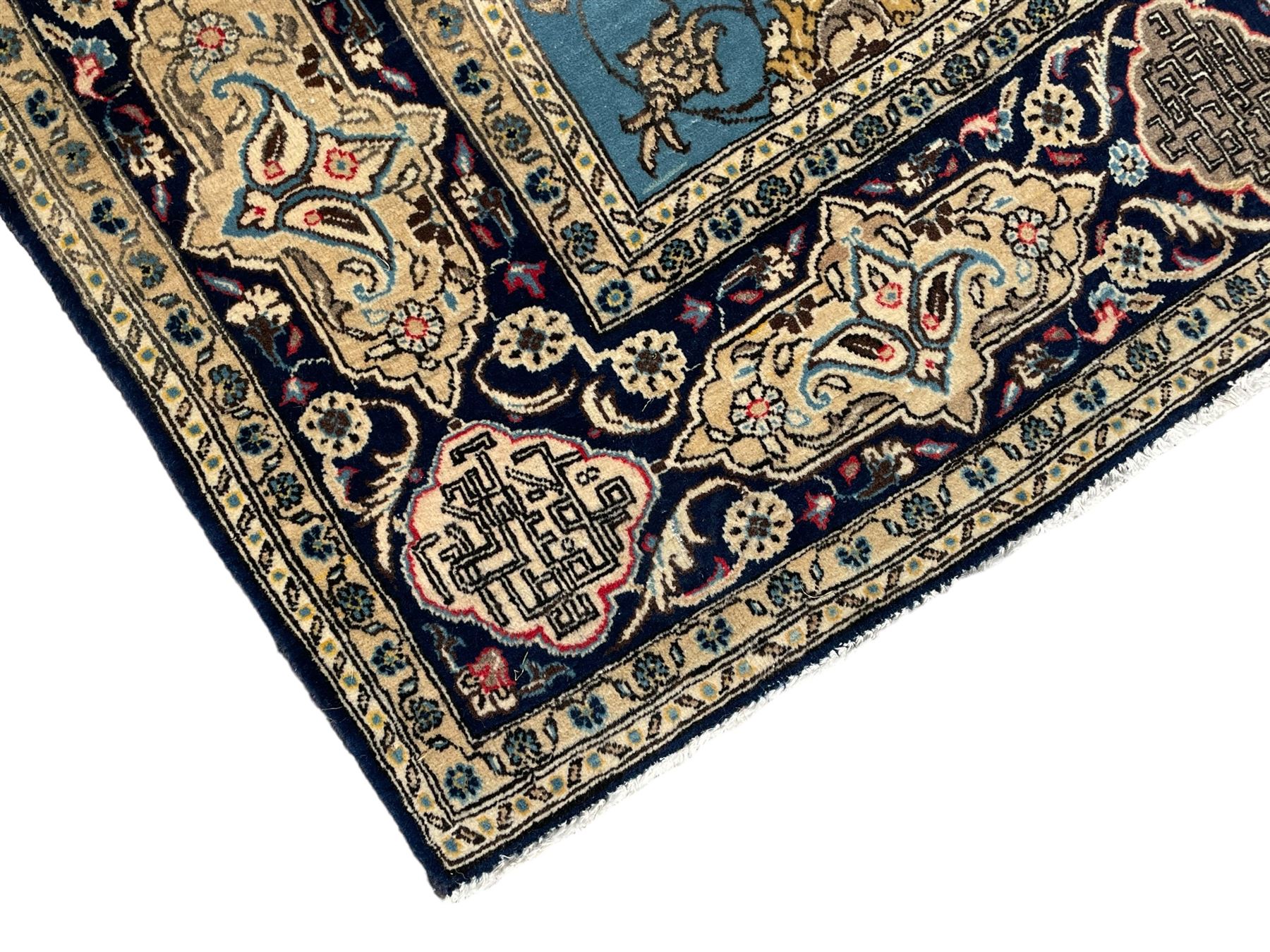 Persian Nain blue ground rug, overall arabesque design, the busy field decorated with interlacing branches and palmettes, indigo ground border with panels decorated with knots and lotus flower motifs, surrounded by trailing branches and flower heads, within guard stripes