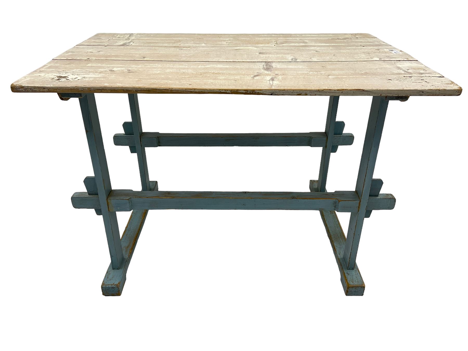 Early 20th century pine rustic dining table, rectangular plank top with weathered patina, over trestle-style supports in distressed blue paint with central stretcher