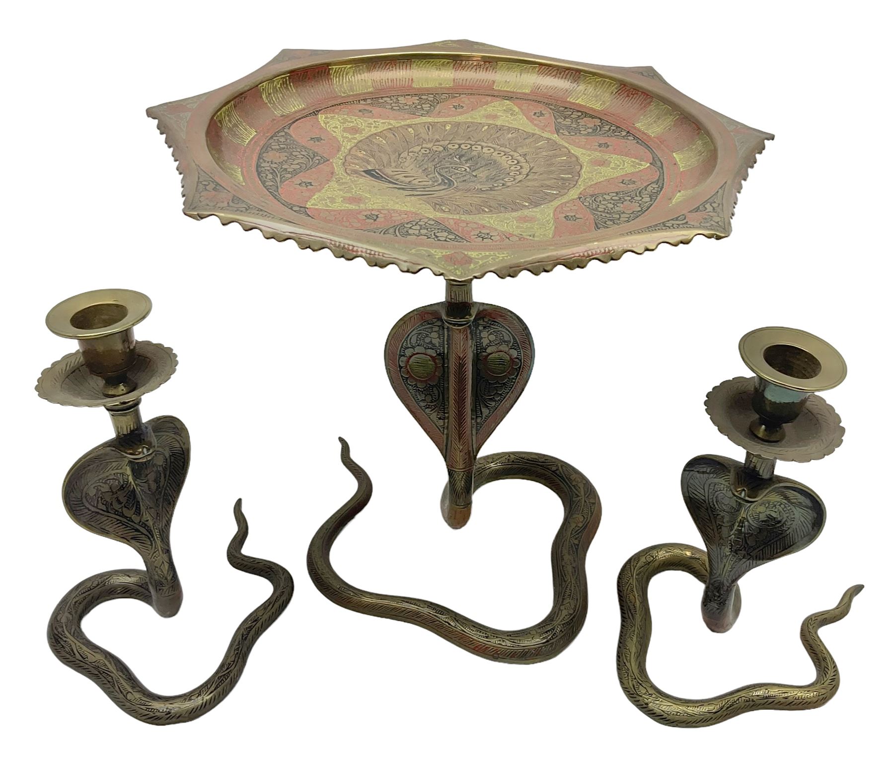 Indian brass pedestal dish, the dish engraved with peacock to centre, the stem modelled as a King Cobra, with engraved and enamelled decoration throughout, together with a similar pair of candlesticks, modelled as King Cobras, dish H23.5cm 