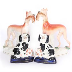 Pair of standing Staffordshire whippets with rabbits in their mouths, together with a pair of Staffordshire spaniels, whippets H30cm