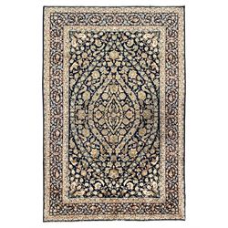 Persian Kashan indigo ground rug, the field consisting of trailing flower head bands and l...