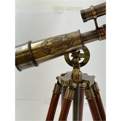 Brass telescope upon a wooden adjustable tripod, H55cm 