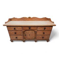 Victorian scumbled pine and sycamore dresser base, the sycamore top framed within shaped g...