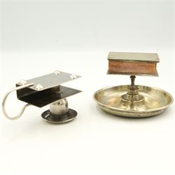 Three Victorian and later silver-plated combination matchbox holders/ candlesticks, a silver-plated combination matchbox holder and ashtray, an early 20th century papier mache wall pocket with striker and a leather matchbox holder in the form of a slipper (6)