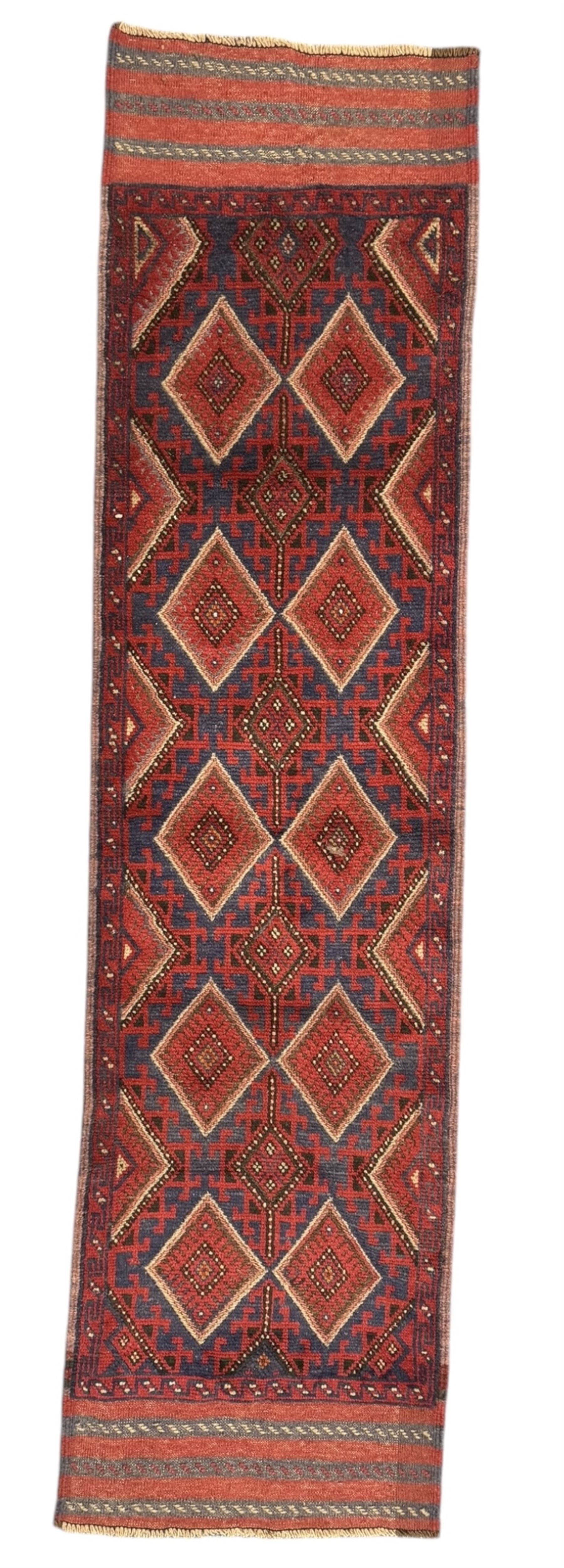 Pashtun Meshwani ground runner, central field decorated with rows of multicoloured diamond medallions, surrounded by geometric motifs, wide red and blue striped border with additional guard bands