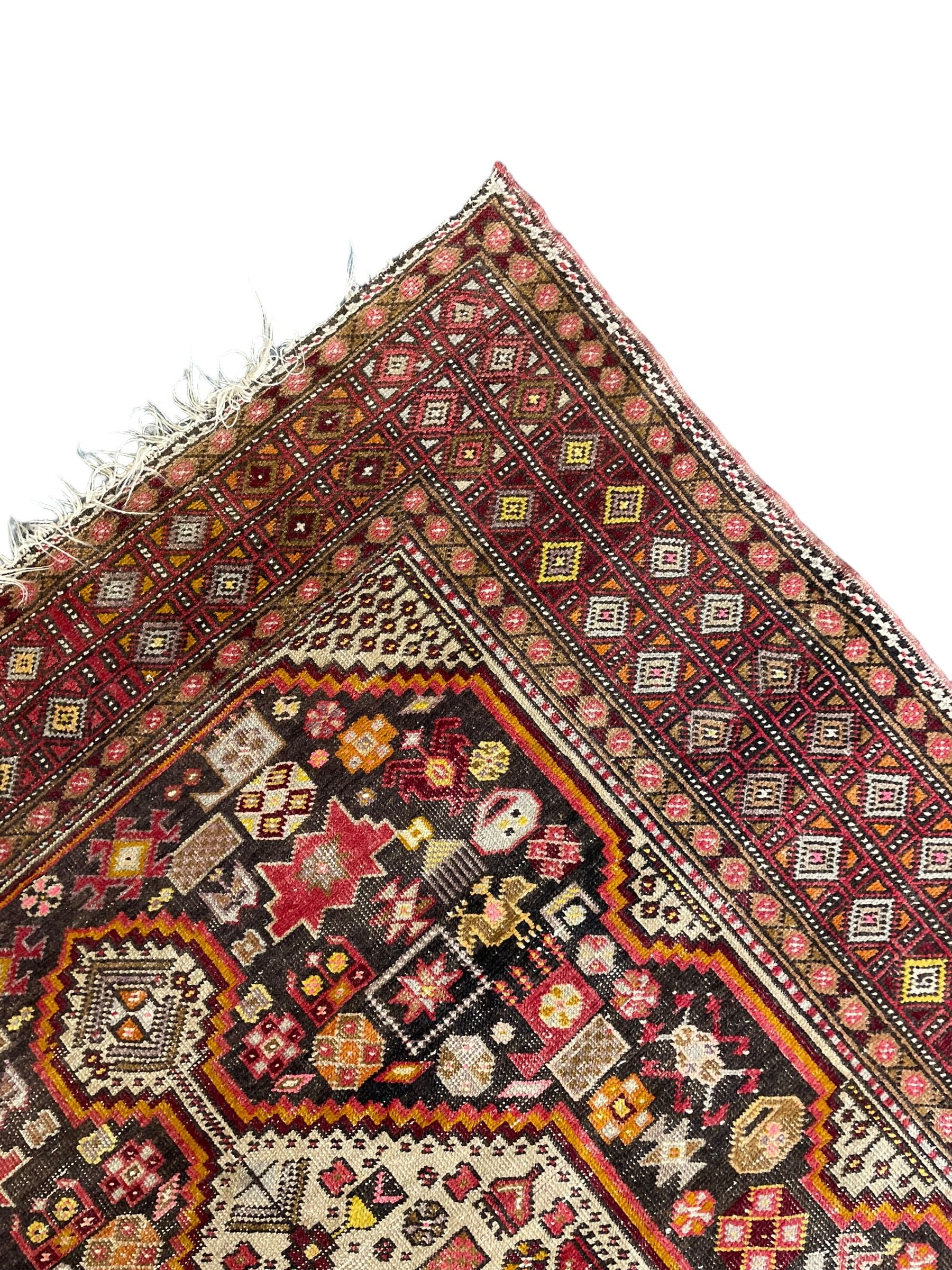 Persian Hamadan dark indigo ground rug, the field decorated with two connected pole medallions, decorated all over with small geometric and stylised bird motifs, geometric design border with repeating pattern 