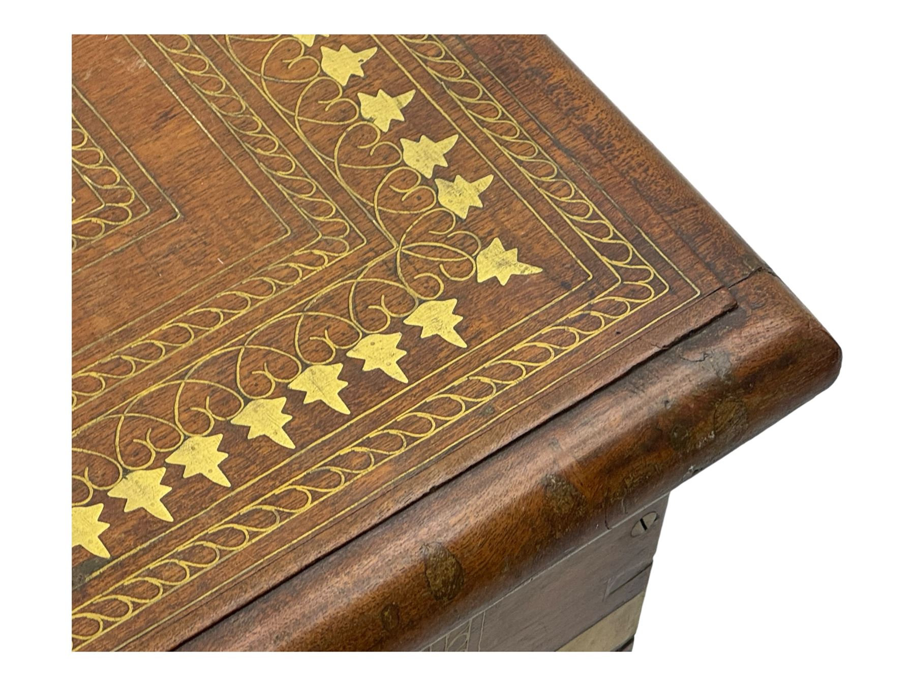 20th century mahogany chest, rectangular hinged top enclosing removable compartments with carved starburst motifs with linear and geometric patterns, brass inlay to the top and front, mounted corners and edges, on bracket base