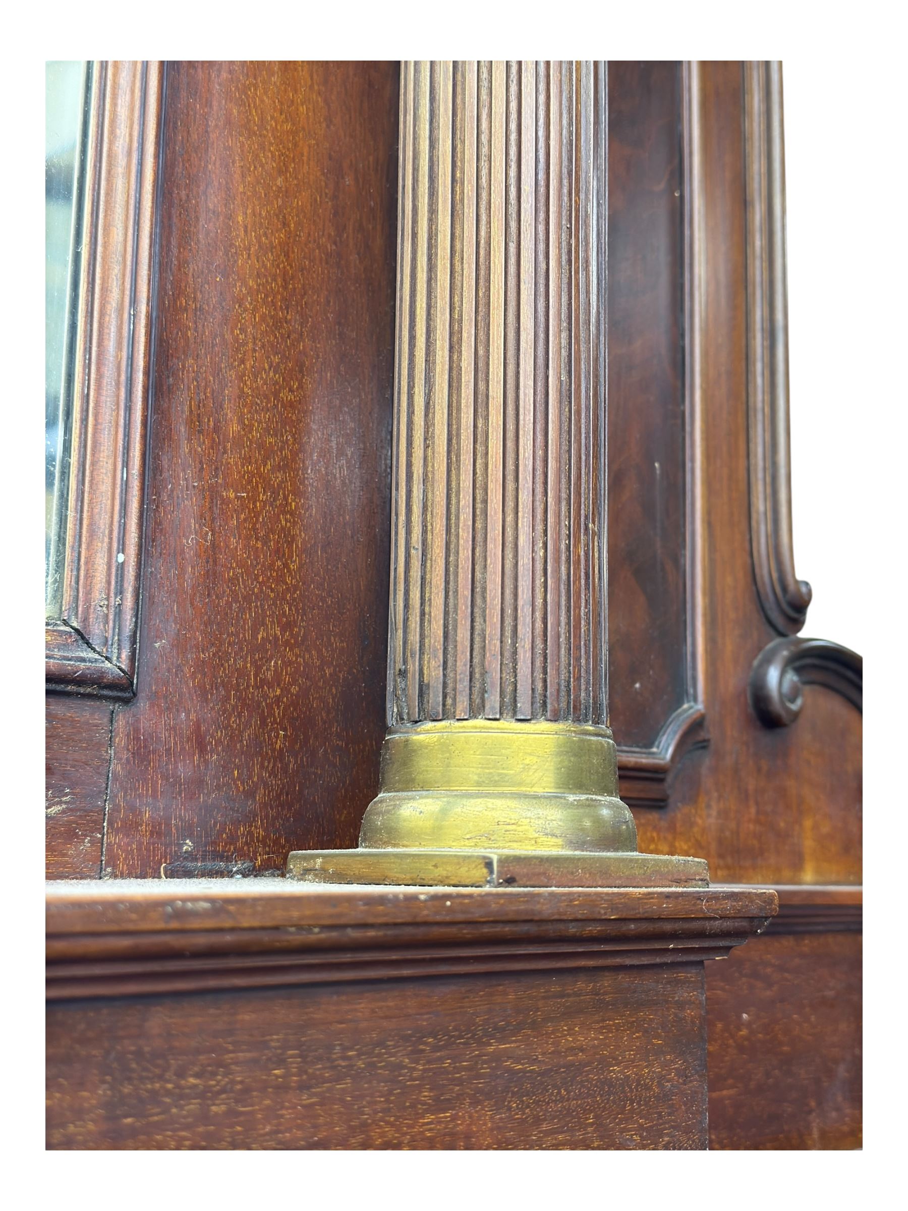 19th century mahogany sideboard, raised mirror back with carved fretwork and two fluted columns, above two cupboards and two drawers with lion mask handles