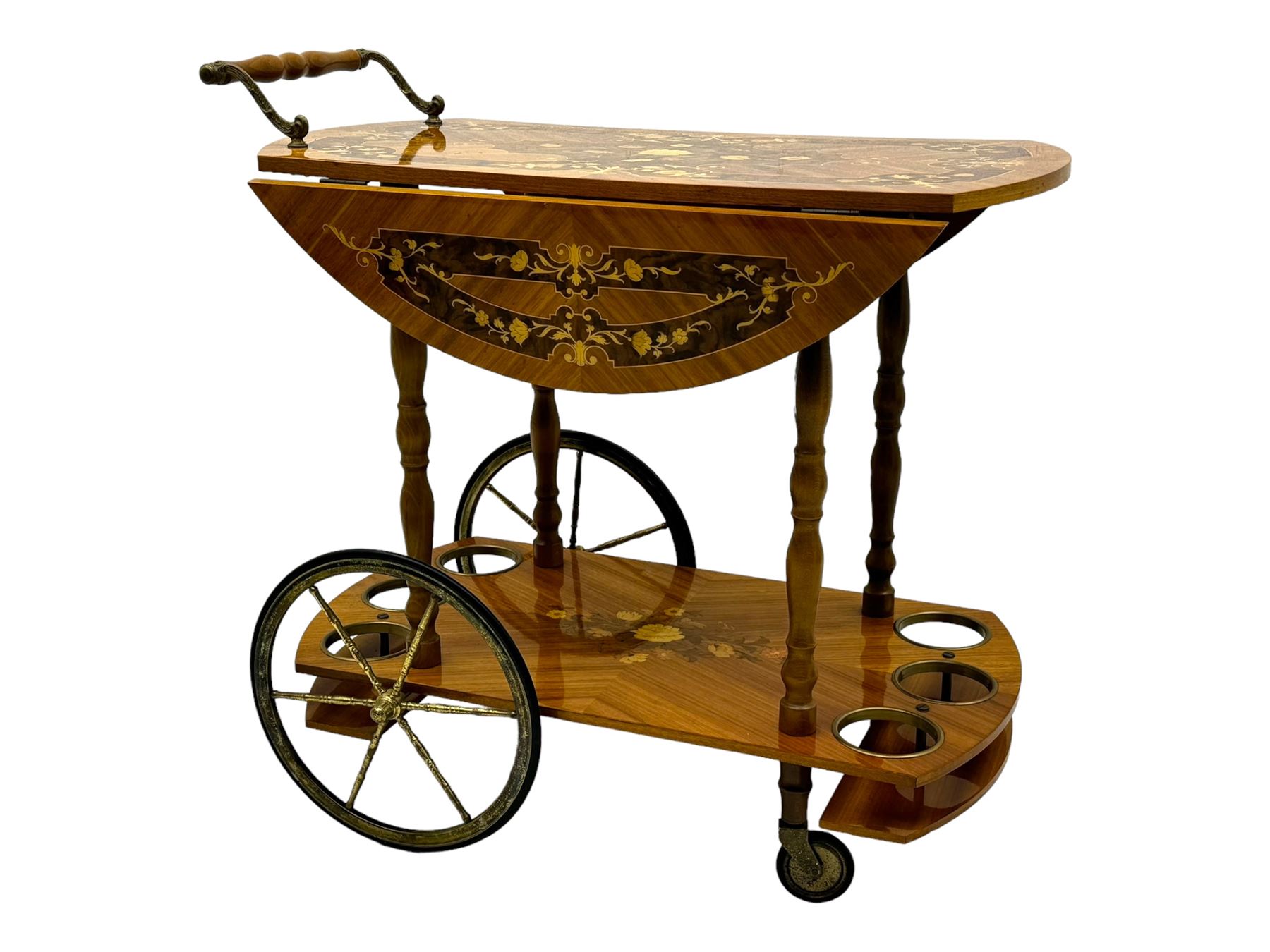 Mid 20th century walnut and satinwood drinks trolley, drop-leaf top with Italian marquetry, turned supports connecting lower shelf fitted with bottle holders and additional storage, on large brass-spoked wheels