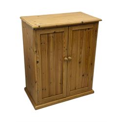 Pine cupboard, rectangular moulded top over two panelled doors enclosing two plank shelves, on plinth base