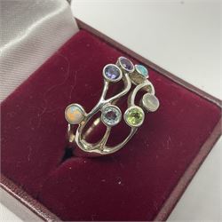 Silver ring, set with seven gemstones including opal, moonstone and peridot, stamped 925, boxed 