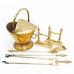 Victorian brass helmet shaped coal scuttle, with embossed fruit and foliate decoration, H47cm; with a collection of tools and tool rests, including a poker, shovel and tongs