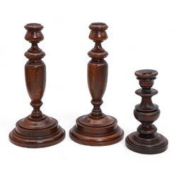 Pair of turned pine candlesticks with baluster stems, H30cm, together with a similar small...