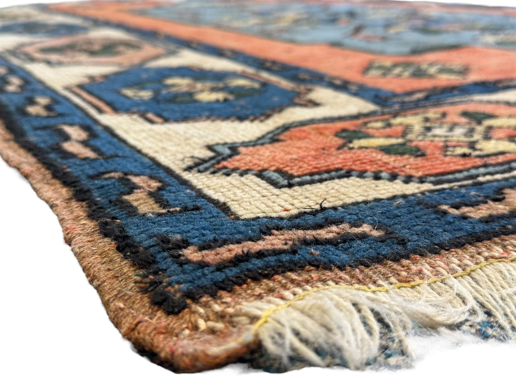 Turkish indigo ground rug, the shaped central field decorated with a central geometric stylised plant motif, enclosed with a guarded border decorated with contrasting motifs 