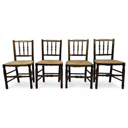 Set of four 19th century elm spindle back chairs, bar cresting rail over three turned vertical spindles, rush seat on turned supports united by turned stretchers 