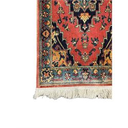 Northwest Persian salmon ground runner, the field decorated with a series of geometric medallions, surrounded by a multi-band border with floral motifs