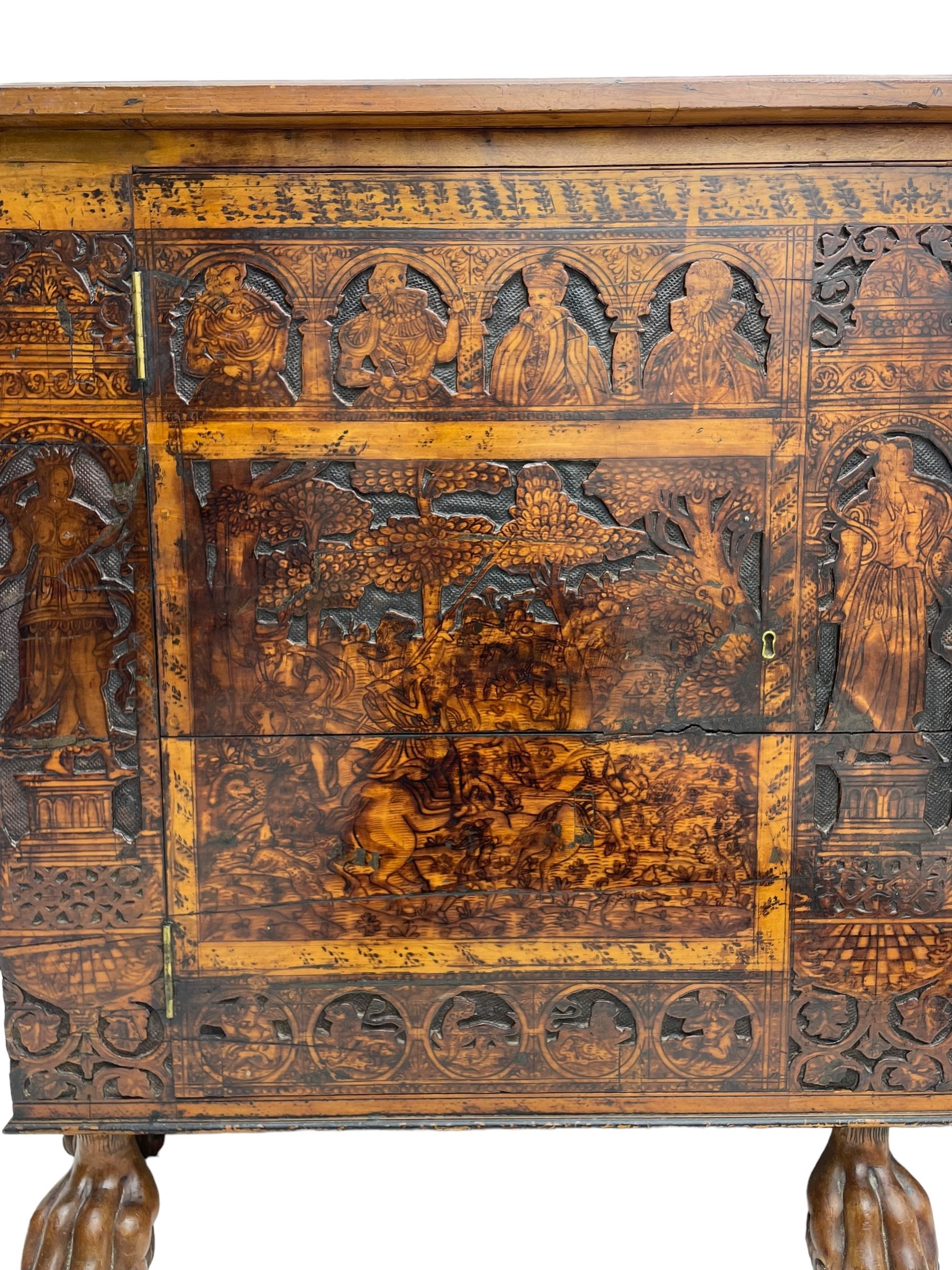 17th century and later cedarwood and pine side cupboard, moulded rectangular top, enclosed by two doors possibly removed and reused from a Venetian Cassone, carved and decorated with penwork, the upper architectural arcade with busts of noblemen, the larger decoration depicting hunters on horseback within woodland landscape with various animals, central and flanking uprights decorated with classical female figures upon pedestals, lower roundels decorated with lion and putto motifs, overall foliate decoration, raised on five hairy paw carved feet, the interior fitted with shelf