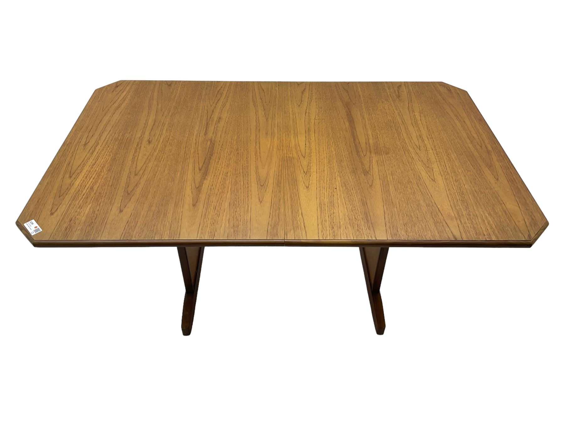 G-Plan -  1970s teak extending dining table, pull-out extending action with fold-out leaf, rectangular end supports on sledge feet united by stretcher (100cm x 160cm - 205cm, H73cm); set of six dining chairs, chevron-patterned backrests upholstered with floral patterned fabric, on tapered legs, H89cm