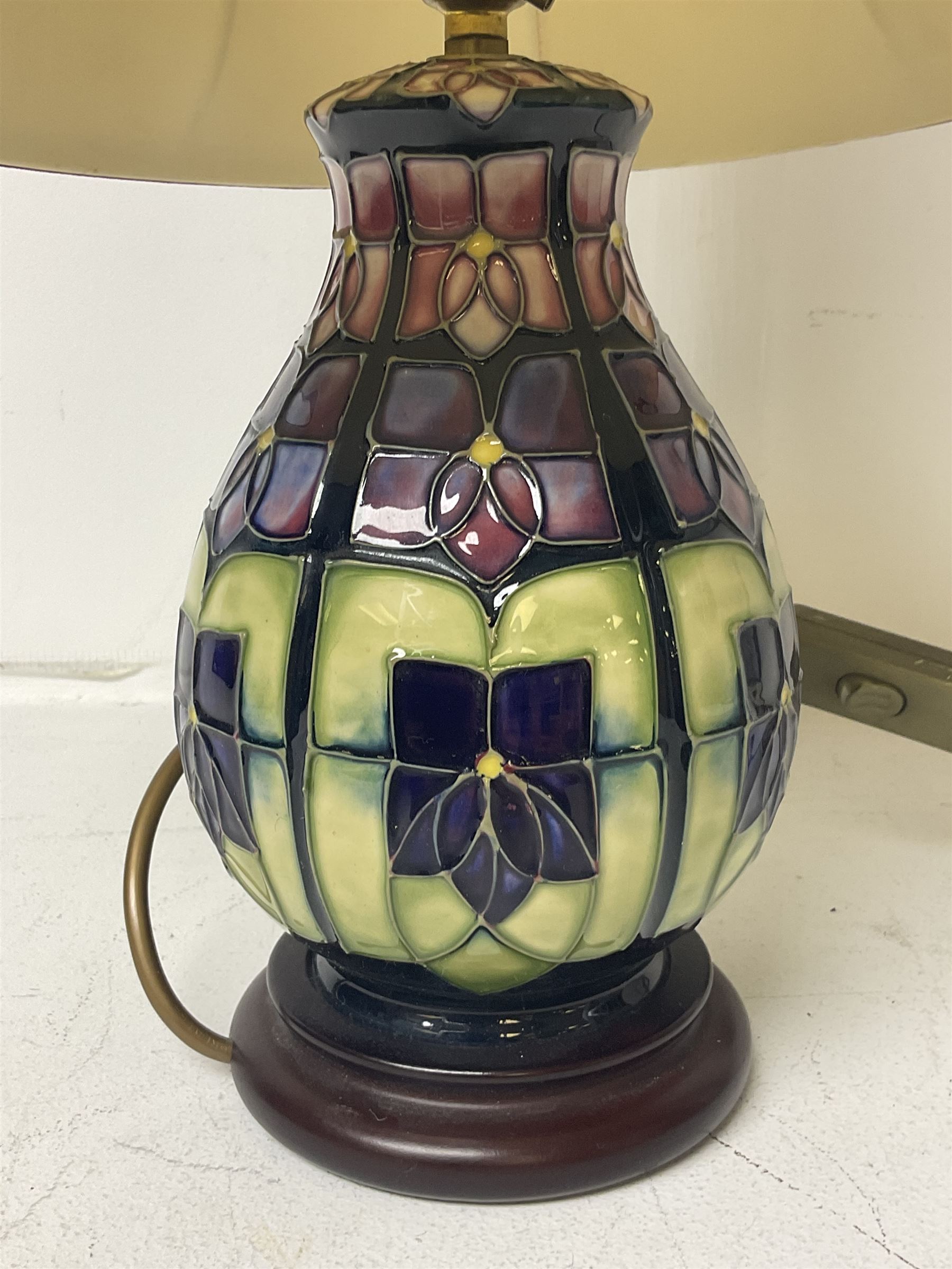 Moorcroft table lamp, of baluster form, decorated in the Violet pattern, on wooden plinth, with accompanying cream shade of lobed form, with piped detail, H23cm (excluding fitting)