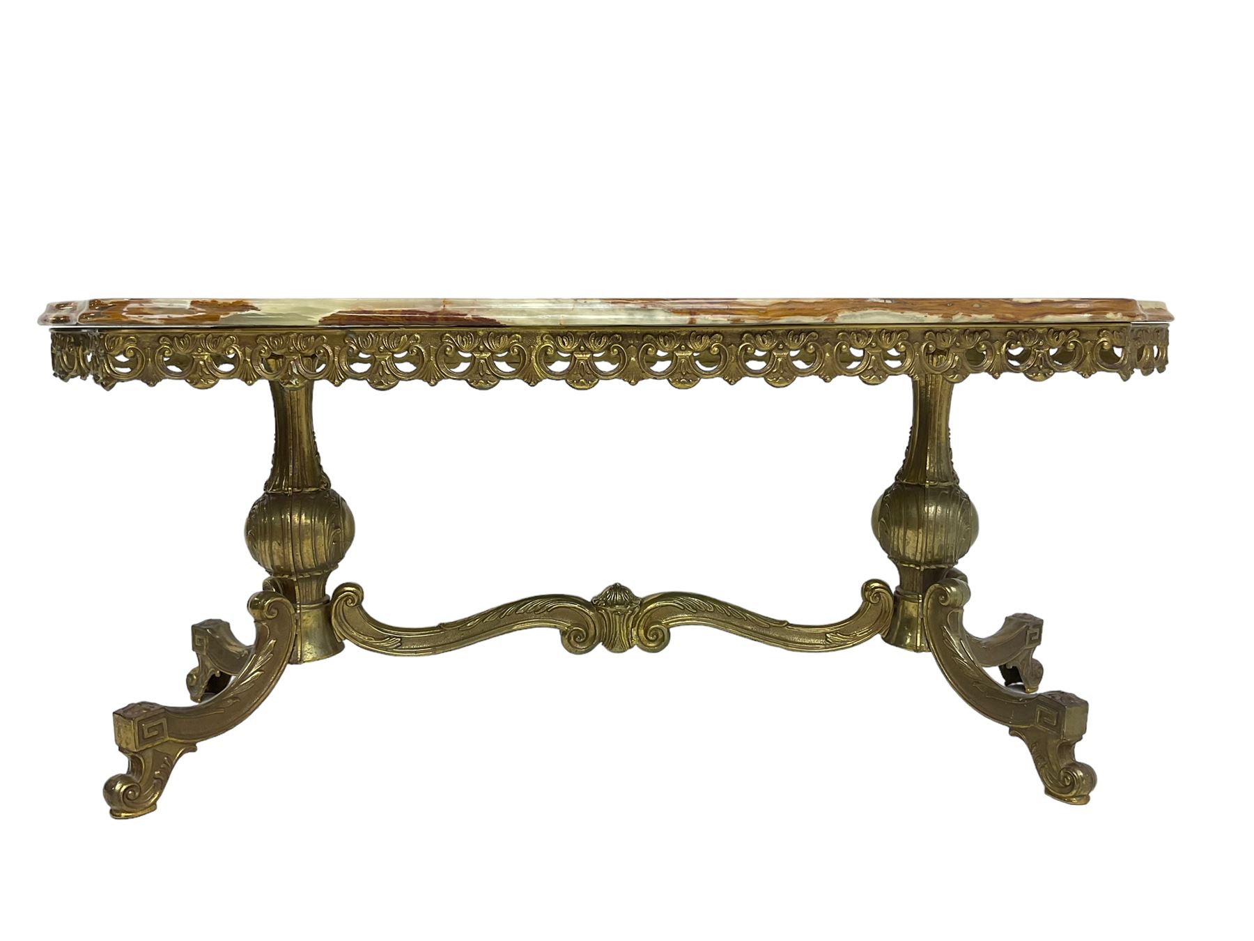 Mid-20th century Italian design Onyx and gilt serpentine coffee table, pierced gilt metal frieze with scrolling decoration, raised on twin end supports with globular turning and foliate decoration united by shaped scroll stretcher