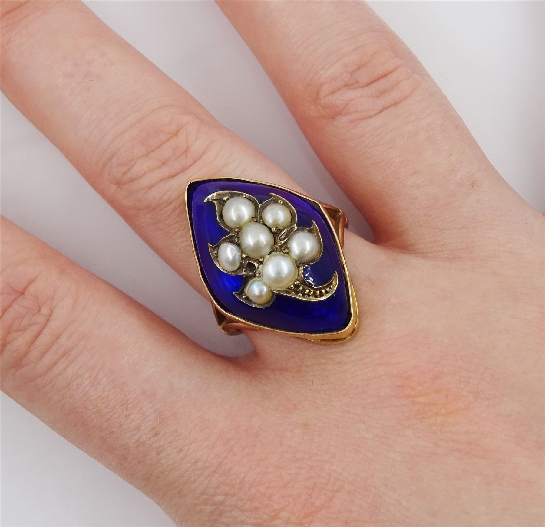 19th / early 20th century 9ct gold marquise shaped ring, the central flower design split pearl  decoration, with blue enamel surround