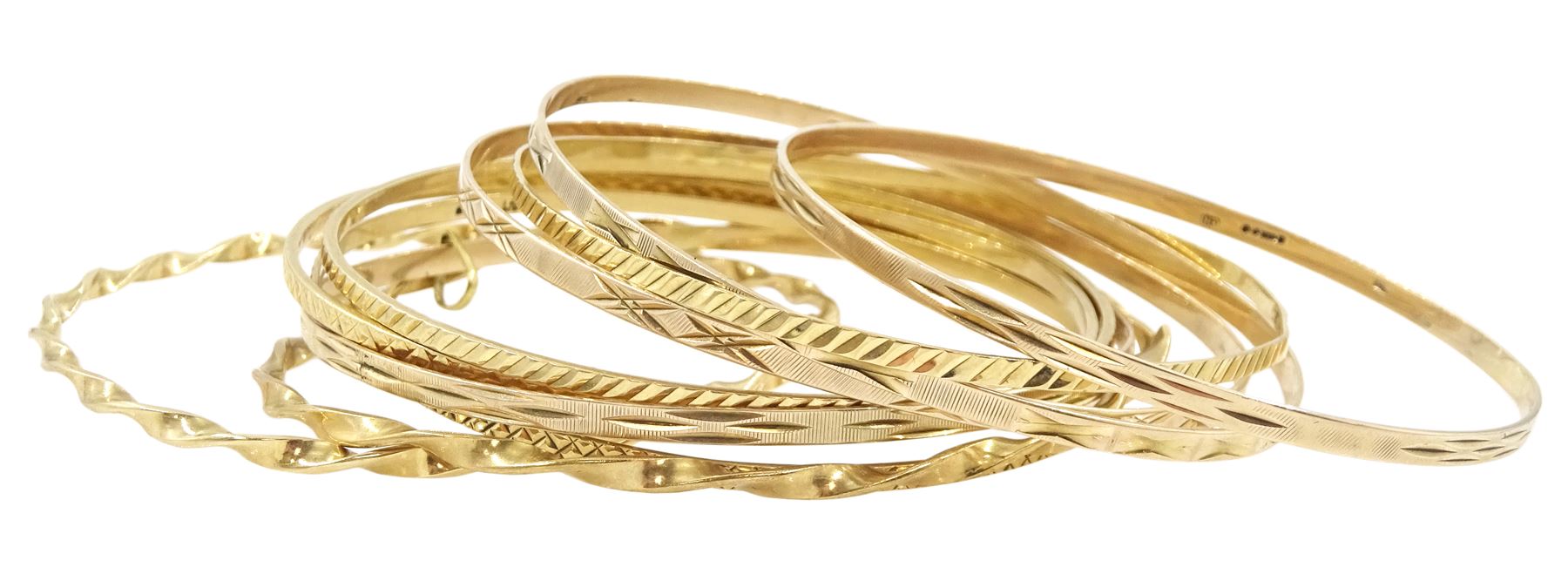 Ten 9ct gold bangles, hallmarked