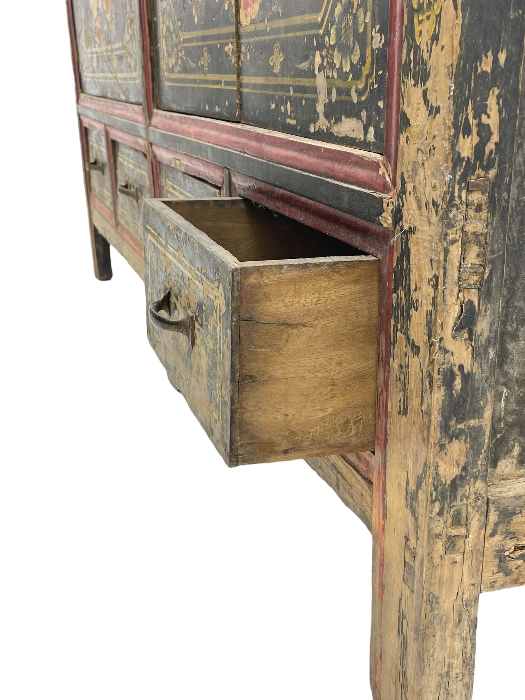 19th century Chinese Qing dynasty painted elm cupboard, Shanxi province, two double cupboards enclosed by doors painted with figure and flower heads, fitted with four small drawer, on stile supports 