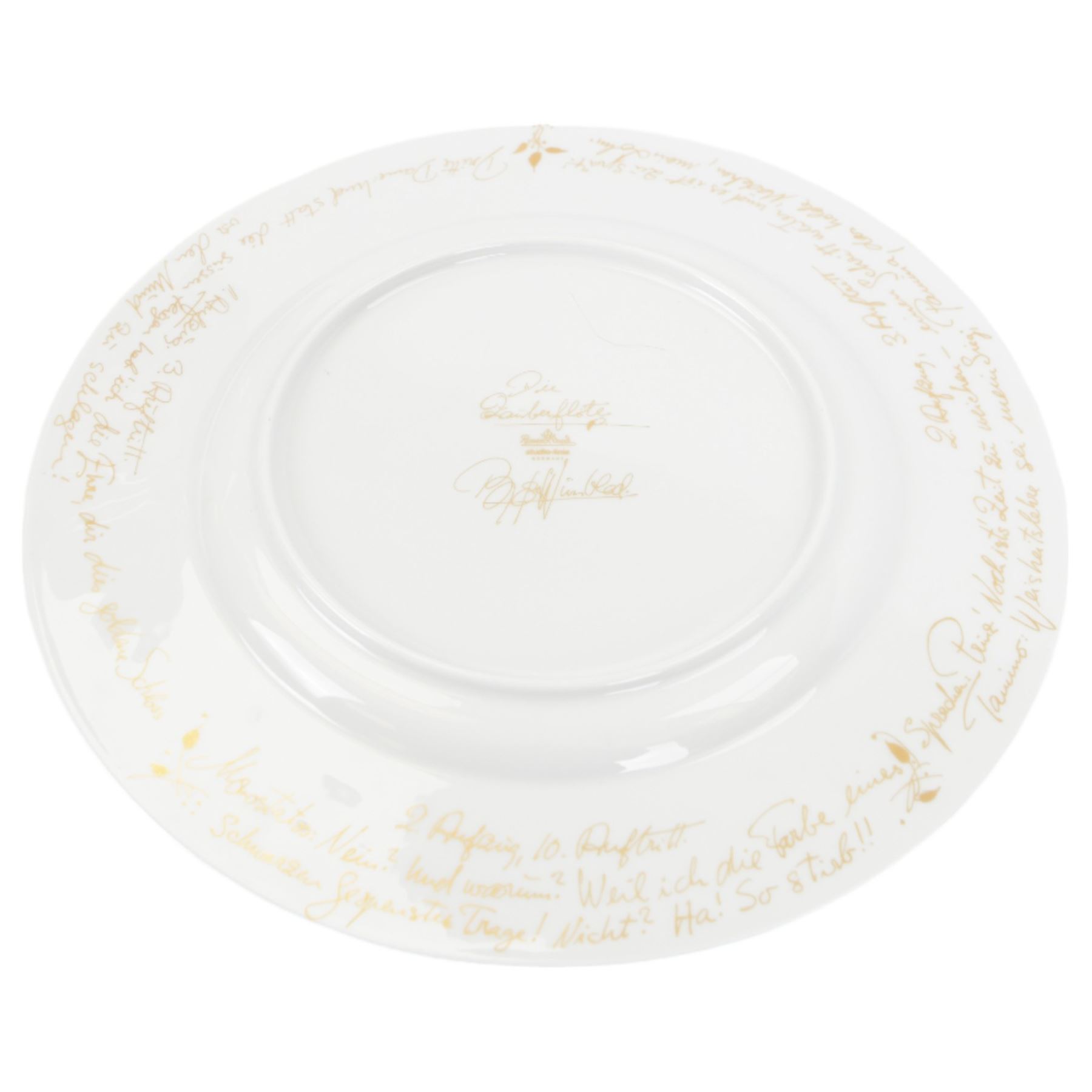 Rosenthal Die Zauberflote pattern dinner plate, designed by Von Bjorn Wiinblad, of circular form the gilt rim decorated in relief with stylised scene's from the Mozart opera,with opera reference inscriptions in German in gilt verso, with printed mark beneath, D32cm