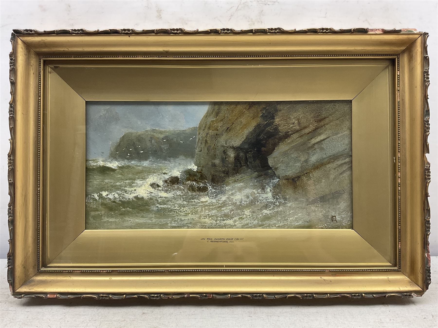 C Rutherford (British early 20th century): ‘On the North East Coast’, oil on canvas signed with monogram, titled and dated 1911 on the slip 16cm x 33cm