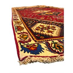 South West Persian Qashqai red ground runner, the crimson field decorated with three connected lozenges, surrounded by small stylised motifs of bird and plants, indigo spandrels with further stylised motifs, the border with repeating floral design 